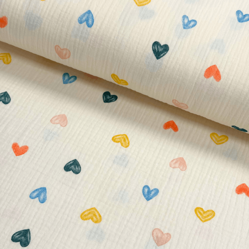 Muslīna audums 140cm | 120-135g/m² - krēmkrāsā ar krāsainām sirsniņām