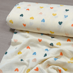 Muslīna audums 140cm | 120-135g/m² - krēmkrāsā ar krāsainām sirsniņām