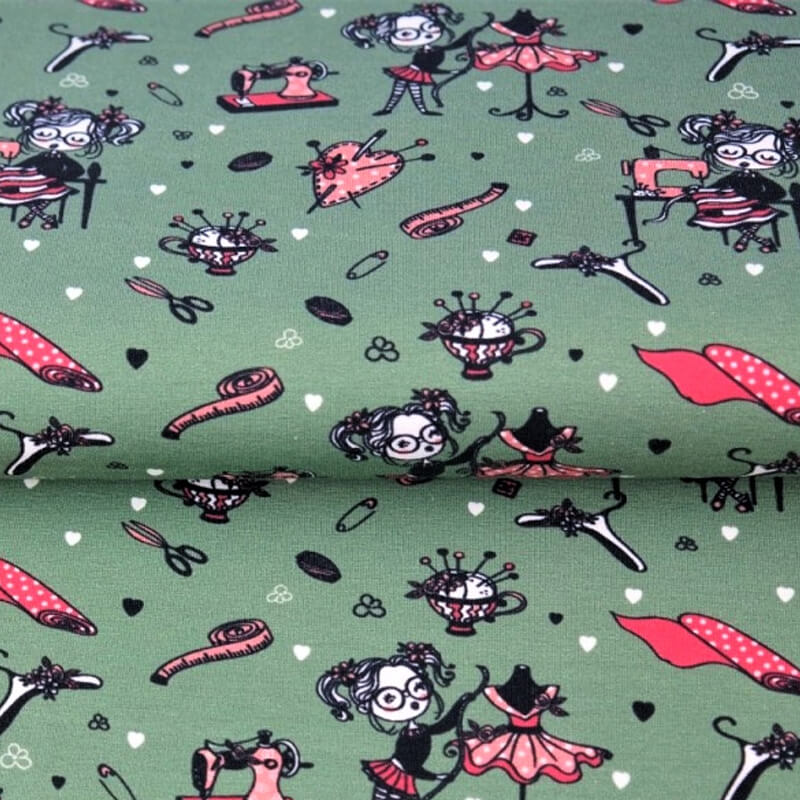 Knitted fabric 150cm | 210g/m² – sewing accessories on a greenish background